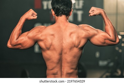 An Male Body Builder Posing For Photo After Hard Work Out.