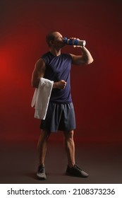 Male Bodybuilder Drinking Protein Shake On Dark Color Background