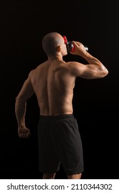 Male Bodybuilder Drinking Protein Shake On Dark Background