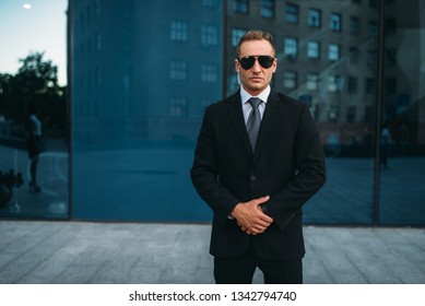 Male Bodyguard In Suit, Earpiece And Sunglasses