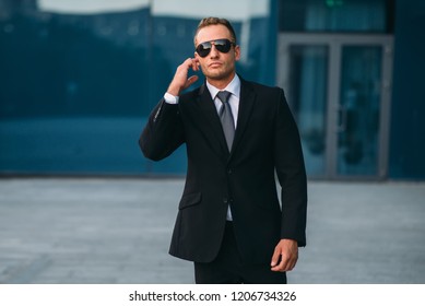 Male Bodyguard Uses Security Earpiece Outdoors