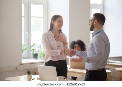 Male Boss Congratulating Female Employee Handshaking And Greeting Her On Special Occasion, Happy Employer Shaking Hand Of Woman Worker Complimenting With Promotion Of Good Work Results. Reward Concept