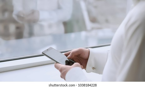 Male Boss Scrolling Touchscreen On Smartphone, Readings News, Window Reflection