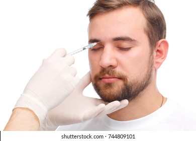 A Male Botox Is Injected Between The Eyebrows. Isolated Over White Background.