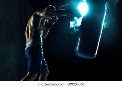 Male Boxer Boxing In Punching Bag