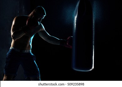 Male Boxer Boxing In Punching Bag