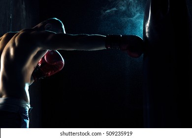 Male Boxer Boxing In Punching Bag