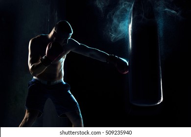 Male Boxer Boxing In Punching Bag