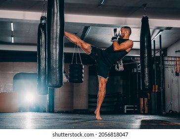 Male boxer as exercise for the big fight. Boxer hits punching bag. Young masculine male athlete - Shutterstock ID 2056818047