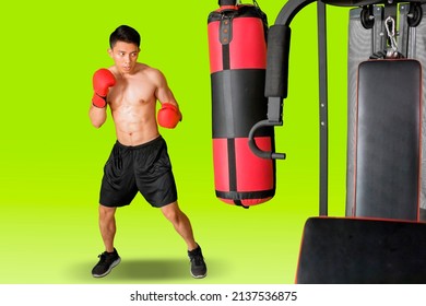 Male boxer exercising with punching bag while standing in the studio with green screen background - Powered by Shutterstock