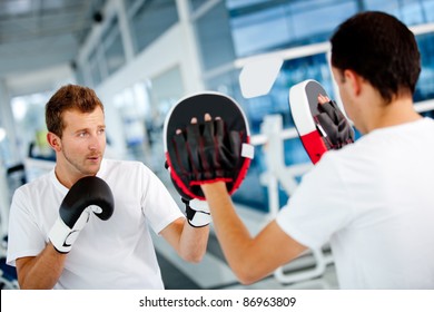 Male boxer at the gym with his trainer - Powered by Shutterstock