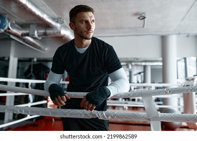 Male boxer leaned on ring ropes - Powered by Shutterstock