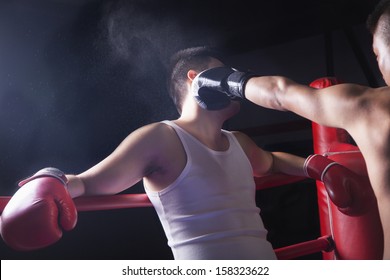 Male Boxer Throwing Knockout Punch In The Boxing Ring