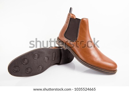 Male brown leather boot on white background, isolated product, comfortable footwear.