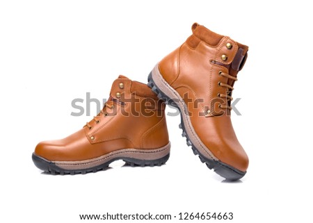 Male brown leather boots on white background, isolated product, comfortable footwear.