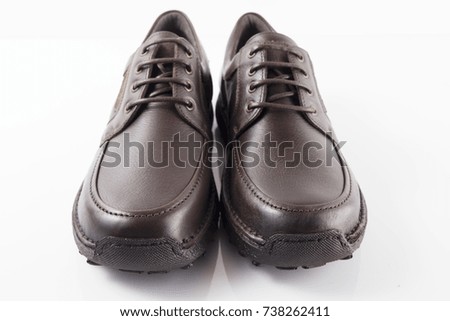 Male brown leather shoe on white background, isolated product, front view.
