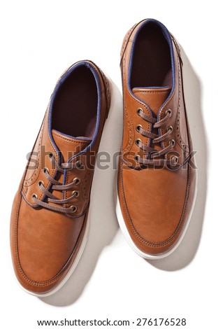 
male brown leather shoes isolated on a white, top view