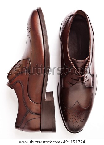 male brown leather shoes isolated on a white, top view

