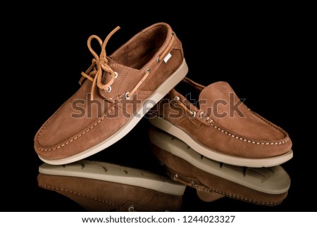 Male brown leather shoes on black background, isolated product, comfortable footwear.
