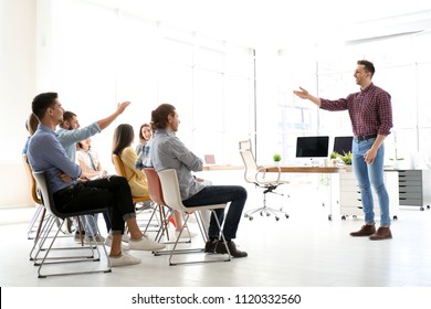 Male Business Trainer Giving Lecture In Office