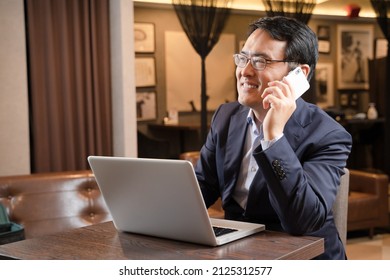 Male Businessman Doing Remote Work At A Cafe