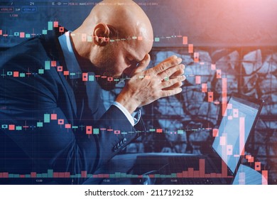 A Male Businessman Is Having A Hard Time Falling Stocks On The Stock Market While Sitting In Front Of A Laptop In The Office. Pose Of A Tired Or Hard Working Person