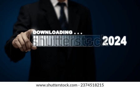 Male businessman is using his fingers to touch the virtual download icon bar in 2024 new year start concept.