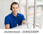 Male call center with headset service support customer by computer. Technical support operator customer service in the office