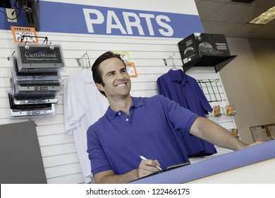 Male Car Mechanic Standing At Counter