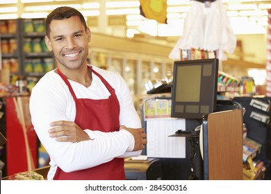 Male Cashier At Supermarket Checkout