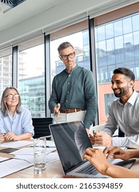 Male caucasian executive ceo businessman leader with diverse partners team, managers group at meeting. Multicultural professional businesspeople working together on business sales plan in boardroom. - Shutterstock ID 2165394859