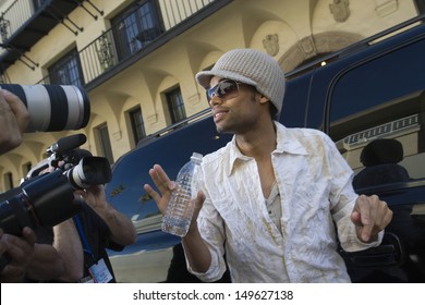 Male Celebrity Being Interviewed By Paparazzi