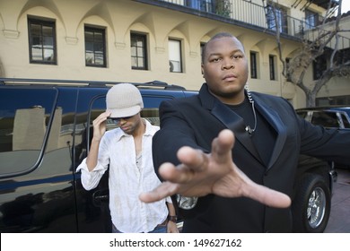 Male Celebrity With His Bodyguard Against A Vehicle