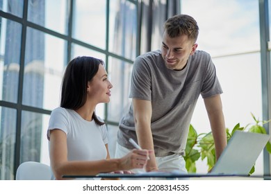 male ceo executive manager mentor giving consultation on financial operations to female colleague using laptop - Shutterstock ID 2208314535