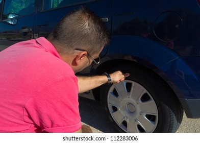 Male Checking The General State Of His Tyres