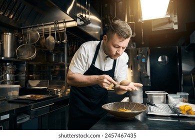 Male chef adding chocolate cream to cookie in plate at table in restaurant - Powered by Shutterstock