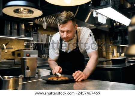 Similar – Image, Stock Photo Concentrated chef adding cream inside ceramic plate