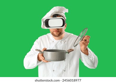 Male chef with cooking pot using VR glasses on green background - Powered by Shutterstock