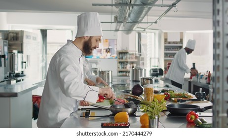 Male Chef Grating Parmesan Cheese On Plate To Cook Italian Dish, Using Grater And Shredded Ingredient To Make Delicious Cuisine Meal. Young Man Cooking Authentic Food Recipe. Tripod Shot.