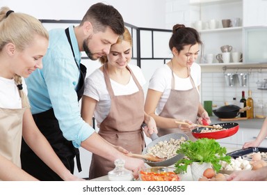 Male Chef And Group Of People At Cooking Classes