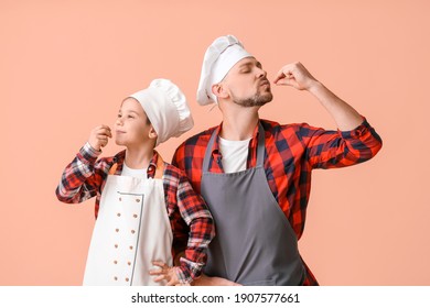 Male chef and his little son on color background - Powered by Shutterstock