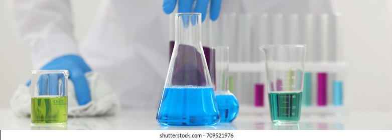 A Male Chemist Holds Test Tube Of Glass In His Hand Overflows A Liquid Solution Of Potassium Permanganate Conducts An Analysis Reaction Takes Various Versions Of Reagents Using Chemical Manufacturing