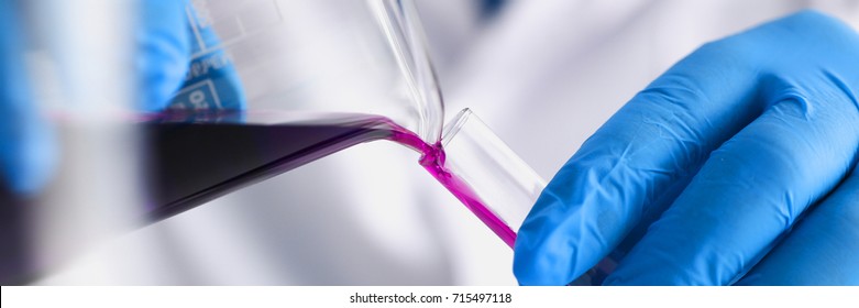 A Male Chemist Holds Test Tube Of Glass In His Hand Overflows A Liquid Solution Of Potassium Permanganate Conducts An Analysis Reaction Takes Various Versions Of Reagents Using Chemical Manufacturing