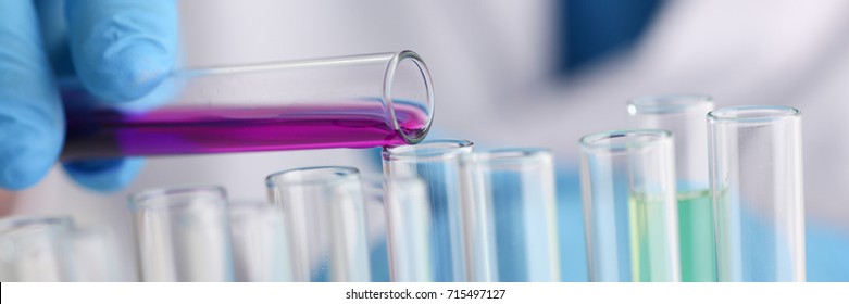 A Male Chemist Holds Test Tube Of Glass In His Hand Overflows A Liquid Solution Of Potassium Permanganate Conducts An Analysis Reaction Takes Various Versions Of Reagents Using Chemical Manufacturing