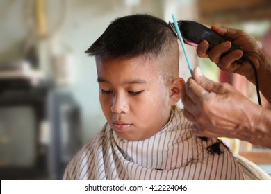 Male Child At The Barber Shop To Cut The Hair