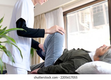 Male chiropractor and male elderly patient who perform leg massage - Powered by Shutterstock