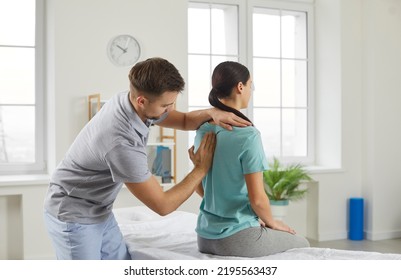 Male chiropractor, physiotherapist or osteopathy specialist examining a female patient with scoliosis or back ache. Physiotherapy, modern orthopaedic therapy, scoliosis treatment concept - Shutterstock ID 2195563437