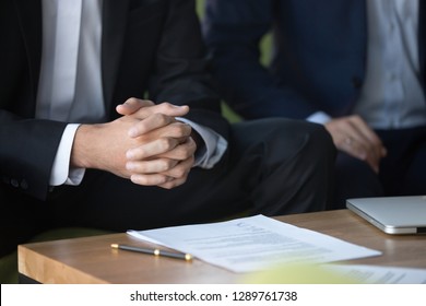 Male Clasped Hands Clenched Together, Businessman At Meeting Negotiations Or Legal Advice Focused On Listening Or Making Decision, Consulting About Contract, Consideration Concept, Close Up View