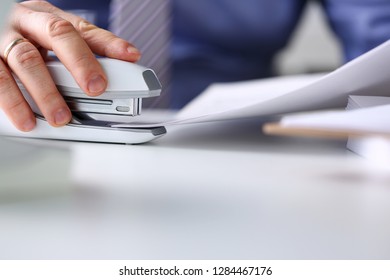 Male Clerk Arm Pin Together Some Papers With Stapler Closeup. Handy Payroll Fastener Bookkeeper Sheet Organization Concept