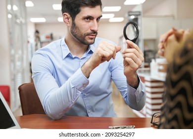 Male client asking question about magnifying glass - Powered by Shutterstock